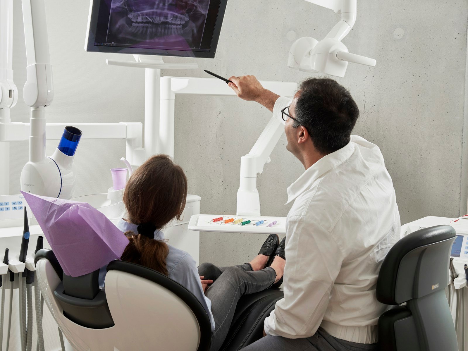 Dentist examining a patient during a dental consultation for toothache